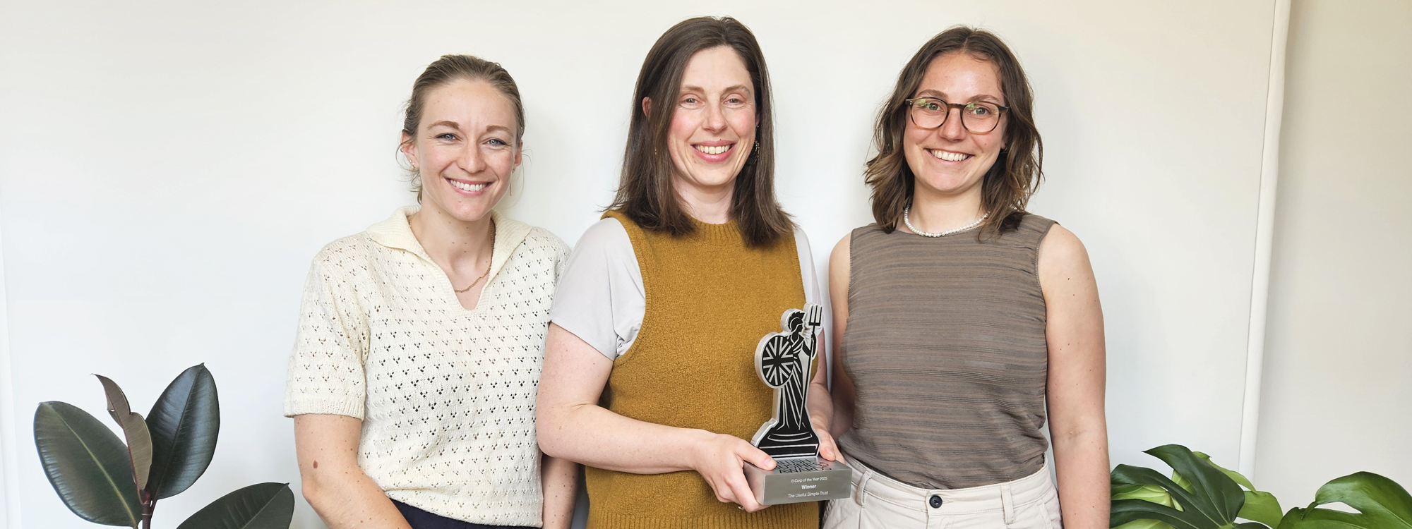 Kate Boylan, Carrie Behar, and Carolyn Bowman with the Trust's 'B Corp of the Year' award